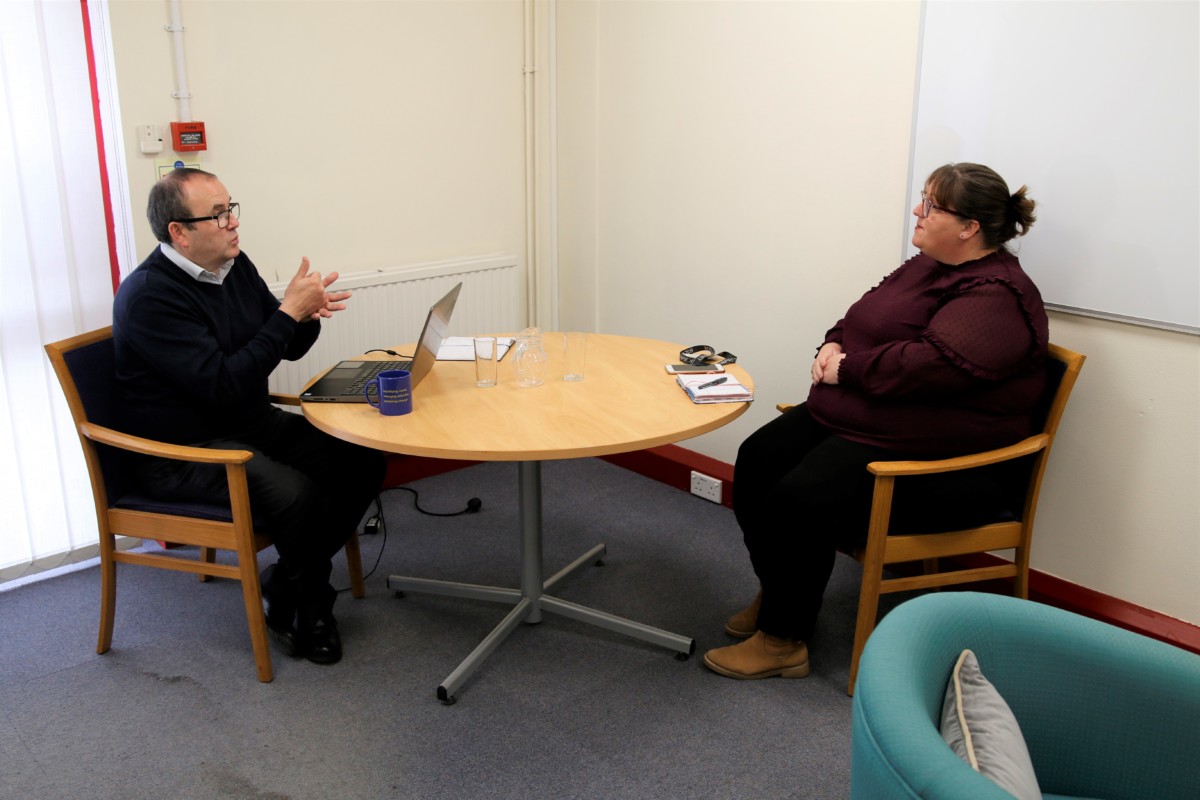 Mark chatting to a colleague in British Sign Language at Living Options Devon. 