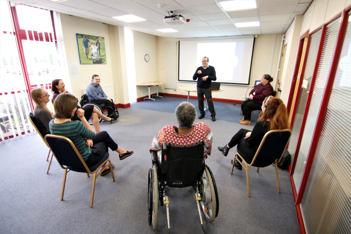 Mark delivering Deaf Awareness Training at the Living Options Devon offices to a group of people